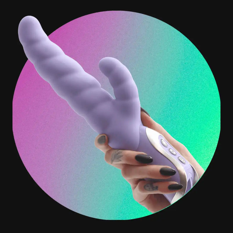 Purple vibrator held by a hand.